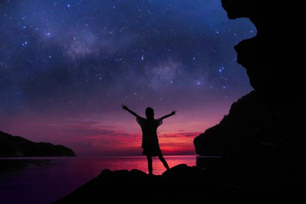 person standing alone under starry night sky experiencing immensheid
