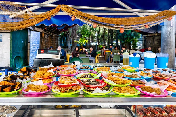 Local vendors and tourists at Boelis Fish Market seafood stalls in Willemstad Curaçao
