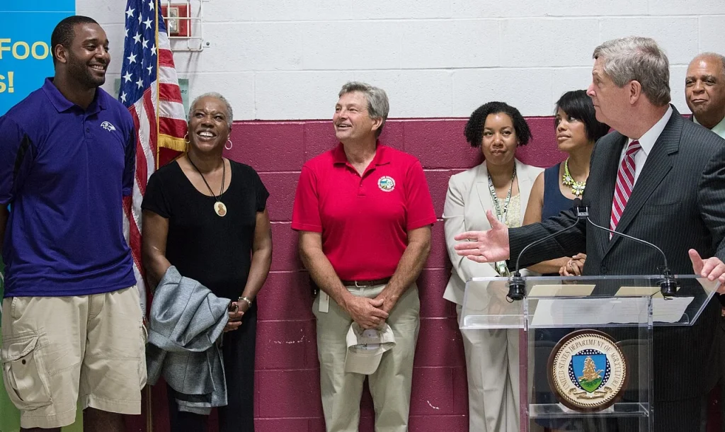 Chris Canty attending a community charity event next to a podium.
