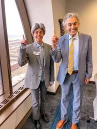 Attorney David Gruber standing with a person next to his famous cardboard cutout.