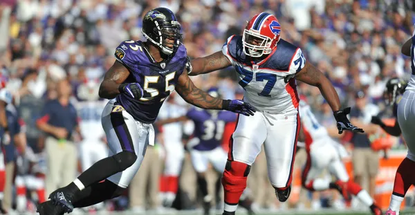 Demetress Bell #77 Buffalo Bills offensive tackle blocking against Baltimore Ravens defender during NFL game