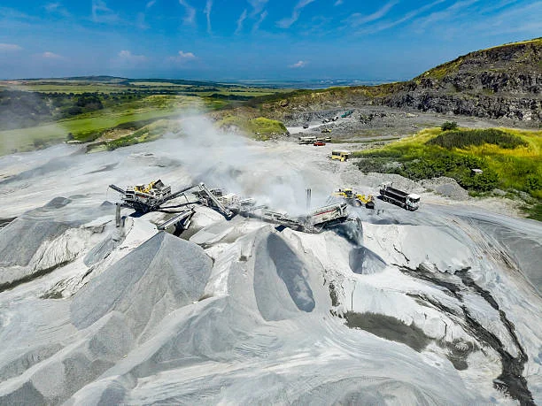 aerial view of active open pit quarry with shared heavy machinery representing maschinenring mining operations