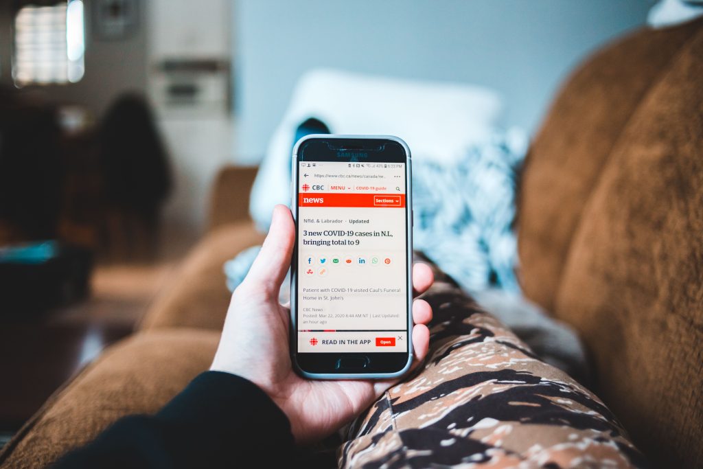 Reader browsing WallPostMedia com articles on mobile screen with clean minimal design
