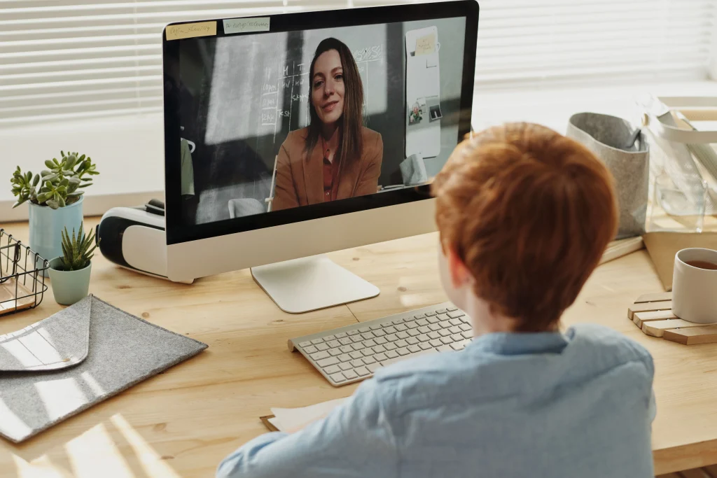 Teacher viewing course dashboard and assignments on a laptop in an online learning platform