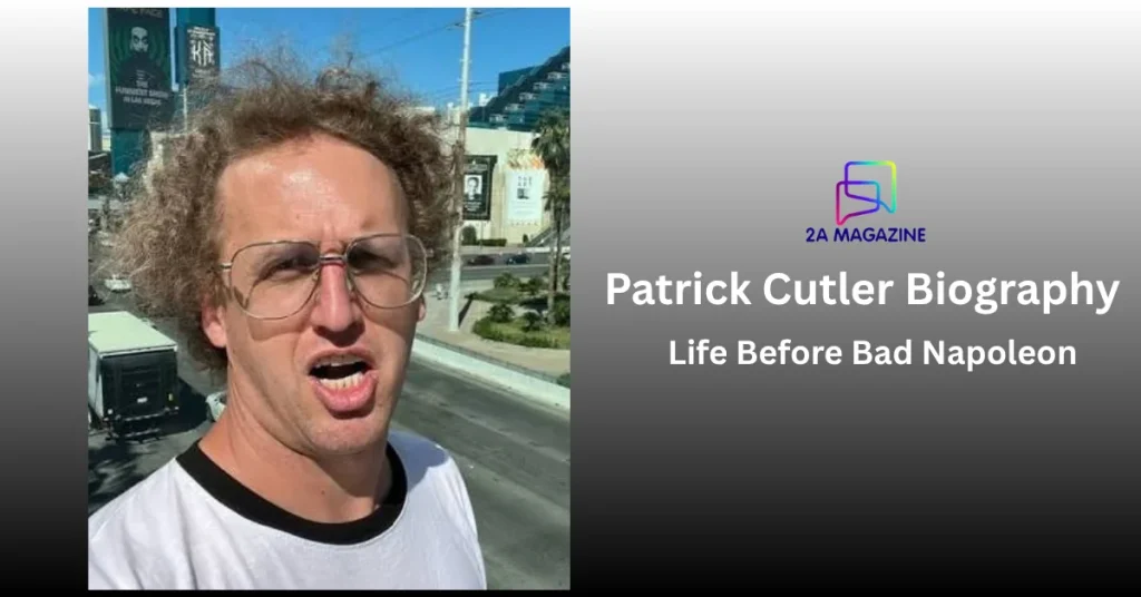 Patrick Cutler as Bad Napoleon in curly wig and aviator glasses