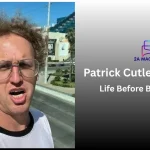 Patrick Cutler as Bad Napoleon in curly wig and aviator glasses
