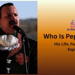 Pepe Aguilar singing in an embroidered black charro suit
