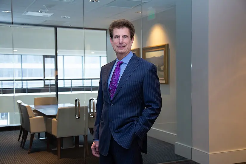 Morris Bart, New Orleans personal injury lawyer, in a pinstripe suit inside his law firm's conference room