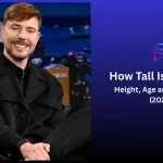 MrBeast (Jimmy Donaldson) seated on a talk-show set in a black jacket — featured image for "How Tall Is MrBeast? Height, Age and Life Story (2026)