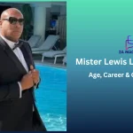 Mister Lewis Lux in a black tuxedo and sunglasses posing beside a luxury resort pool